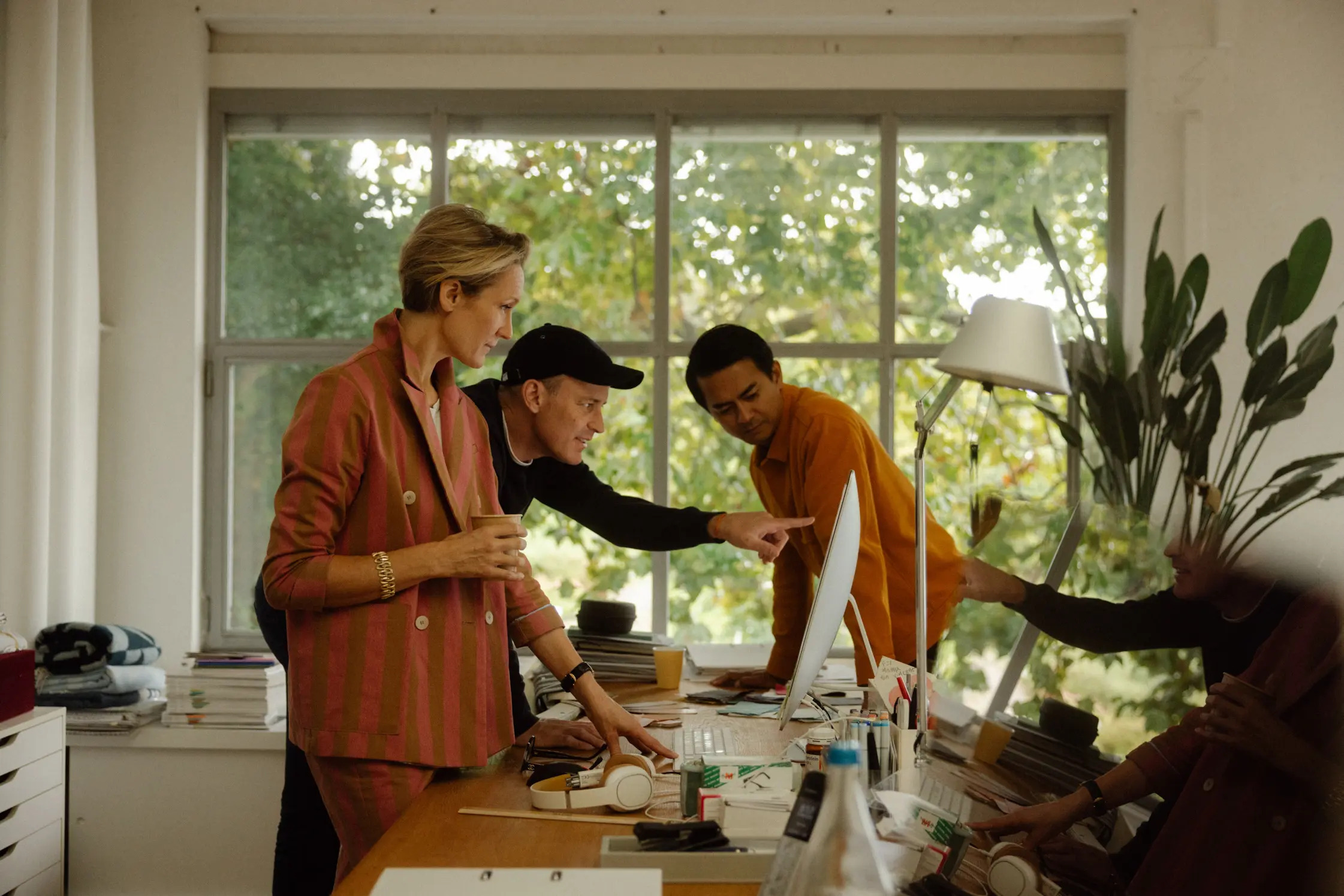 A team collaborating happily around a computer
